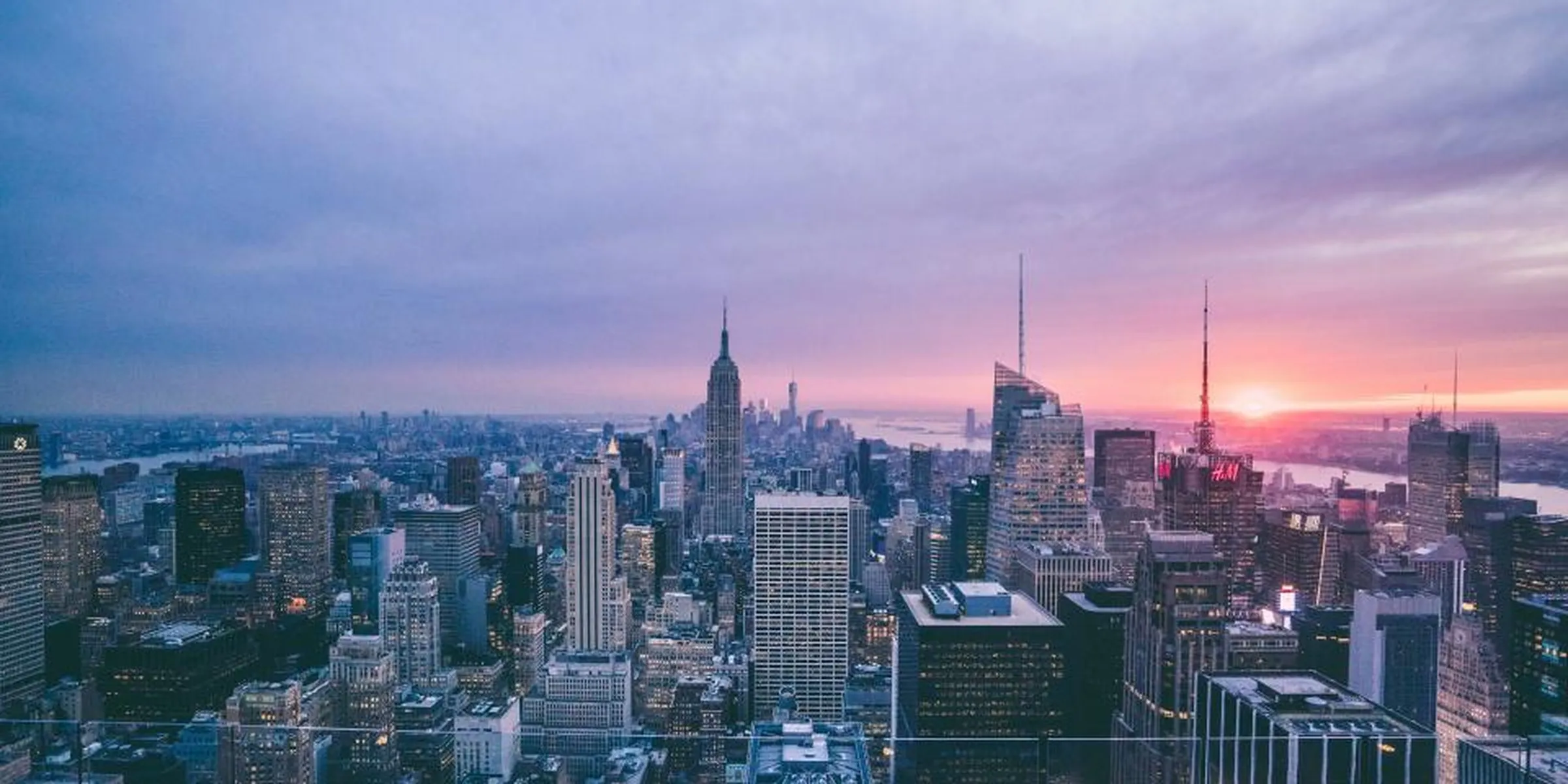 City skyline at sunset representing the wide world of topics covered on Rashywings.com